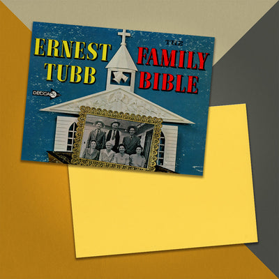 Photo of a 11” x 8.5” notebook cover made from an upcycled Ernest Tubb "The Family Bible" album sleeve and the back cover with yellow cardstock on an orange, cream and grey background.