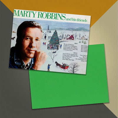 Photo of a 11” x 8.5” notebook cover made from an upcycled Marty Robbins And His Friends "The Joy Of Christmas" album sleeve and the back cover with green cardstock on an orange, cream and grey background.