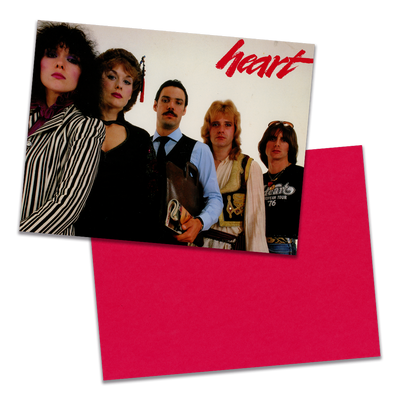 Photo of a 11” x 8.5” notebook cover made from an upcycled Heart "Greatest Hits / Live!" album sleeve and the back cover with red cardstock on a transparent background.