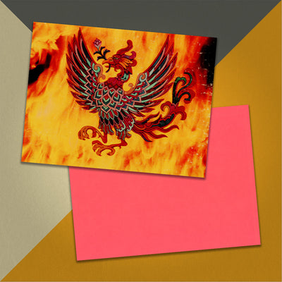 Photo of a 11” x 8.5” notebook cover made from an upcycled Grand Funk "Phoenix" album sleeve and the back cover with coral cardstock on an orange, cream and grey background.