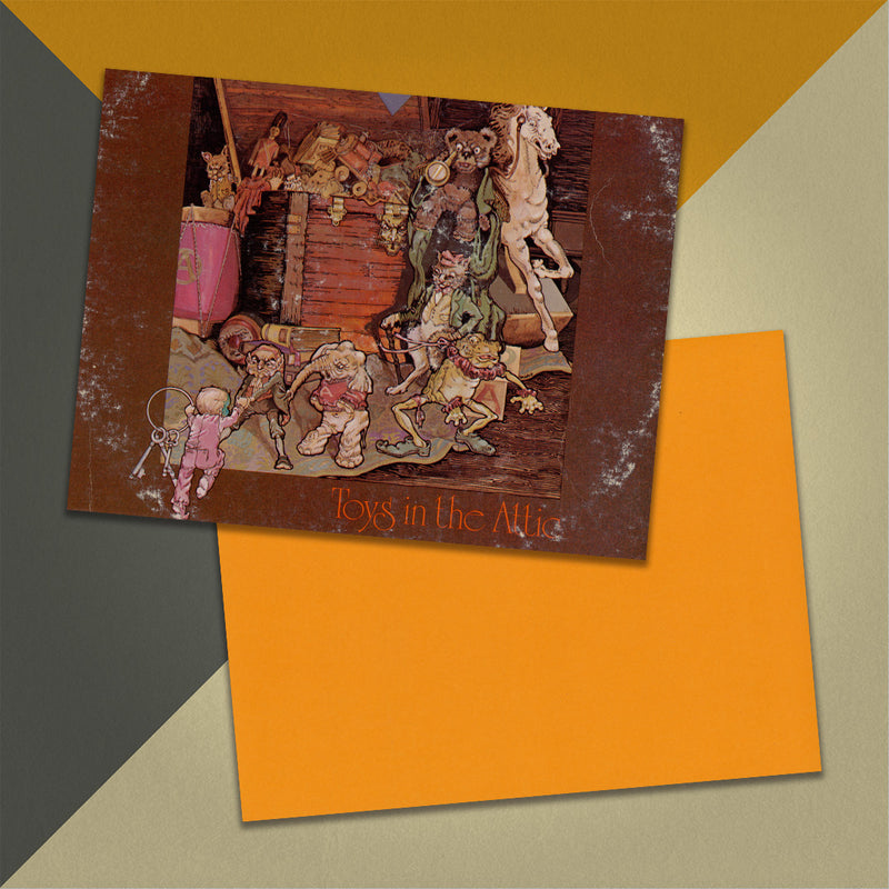 Photo of a 11” x 8.5” notebook cover made from an upcycled Aerosmith "Toys in the Attic" album sleeve and the back cover with orange cardstock on an orange, cream and grey background.