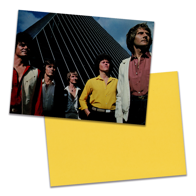 Photo of a 11” x 8.5” notebook cover made from an upcycled Air Supply "Lost in Love" album sleeve and the back cover with yellow cardstock on a transparent background.