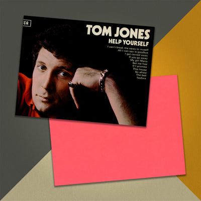 Photo of a 11” x 8.5” notebook cover made from an upcycled Tom Jones "Help Yourself" album sleeve and the back cover with coral cardstock on an orange, cream and grey background.