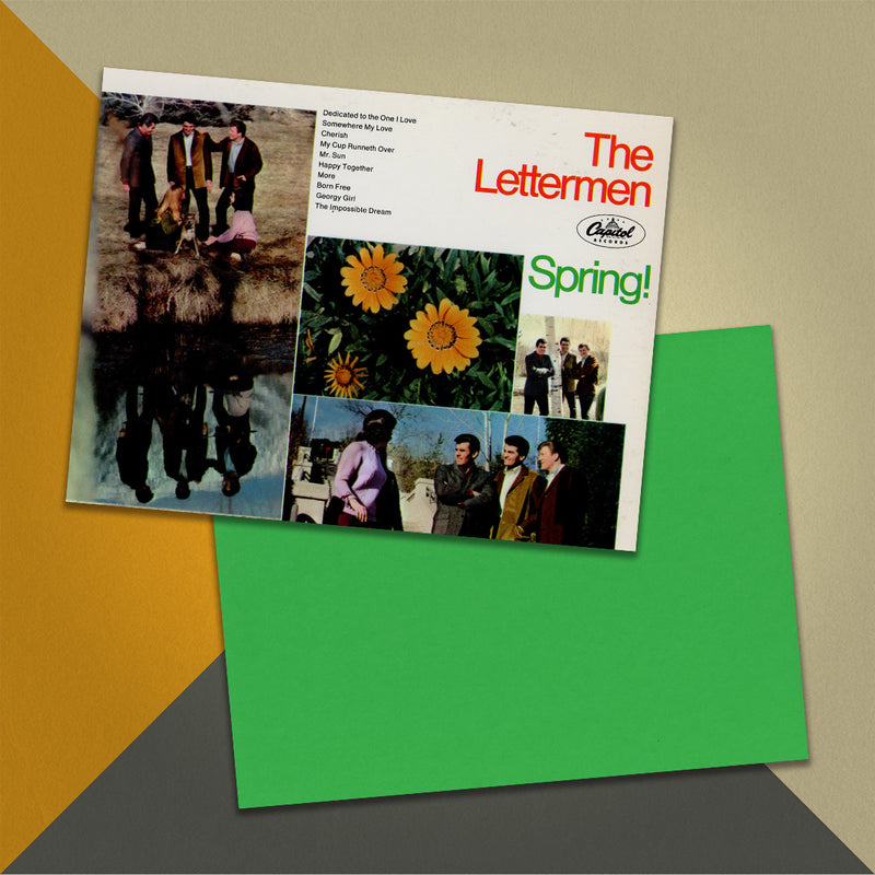 Photo of a 11” x 8.5” notebook cover made from an upcycled The Lettermen “Spring!” album sleeve and the back cover with green cardstock on an orange, cream and grey background.