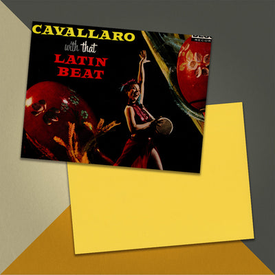 Photo of a 11” x 8.5” notebook cover made from an upcycled Carmen Cavallaro “Cavallaro With That Latin Beat” album sleeve and the back cover with yellow cardstock on an orange, cream and grey background.