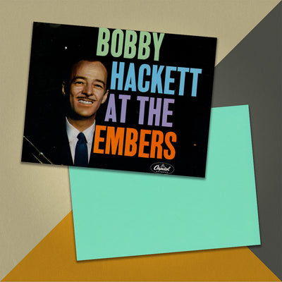 Photo of a 11” x 8.5” notebook cover made from an upcycled The Bobby Hackett Four “Bobby Hackett At The Embers” album sleeve and the back cover with aqua cardstock on an orange, cream and grey background.