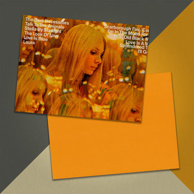 Photo of a 11” x 8.5” notebook cover made from an upcycled Andre Kostelanetz And His Orchestra “Scarborough Fair And Other Great Movie Hits” album sleeve and the back cover with orange cardstock on an orange, cream and grey background.