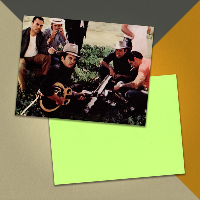 Photo of a 11” x 8.5” notebook cover made from an upcycled Merle Haggard And The Strangers “Pride In What I Am” album sleeve and the back cover with lime green cardstock on an orange, cream and grey background.