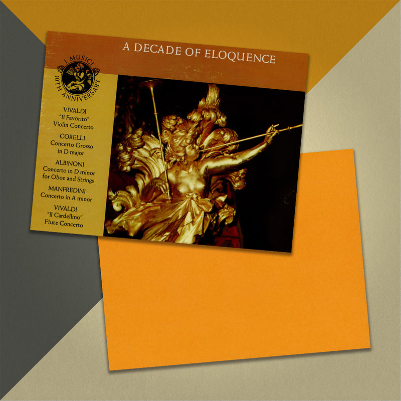 Photo of a 11” x 8.5” notebook cover made from an upcycled I Musici “A Decade Of Eloquence” album sleeve and the back cover with orange cardstock on an orange, cream and grey background.