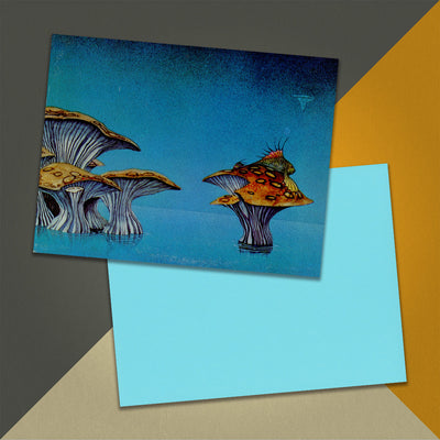 Photo of a 11” x 8.5” notebook cover made from an upcycled Yes “Yessongs” album sleeve and the back cover with bright blue cardstock on an orange, cream and grey background.