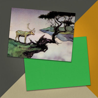 Photo of a 11” x 8.5” notebook cover made from an upcycled Yes “Yessongs” album sleeve and the back cover with green cardstock on an orange, cream and grey background.