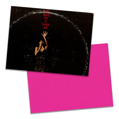 Photo of a 11” x 8.5” notebook cover made from an upcycled Shirley Bassey “Live At Carnegie Hall” album sleeve and the back cover with hot pink cardstock on a transparent background.