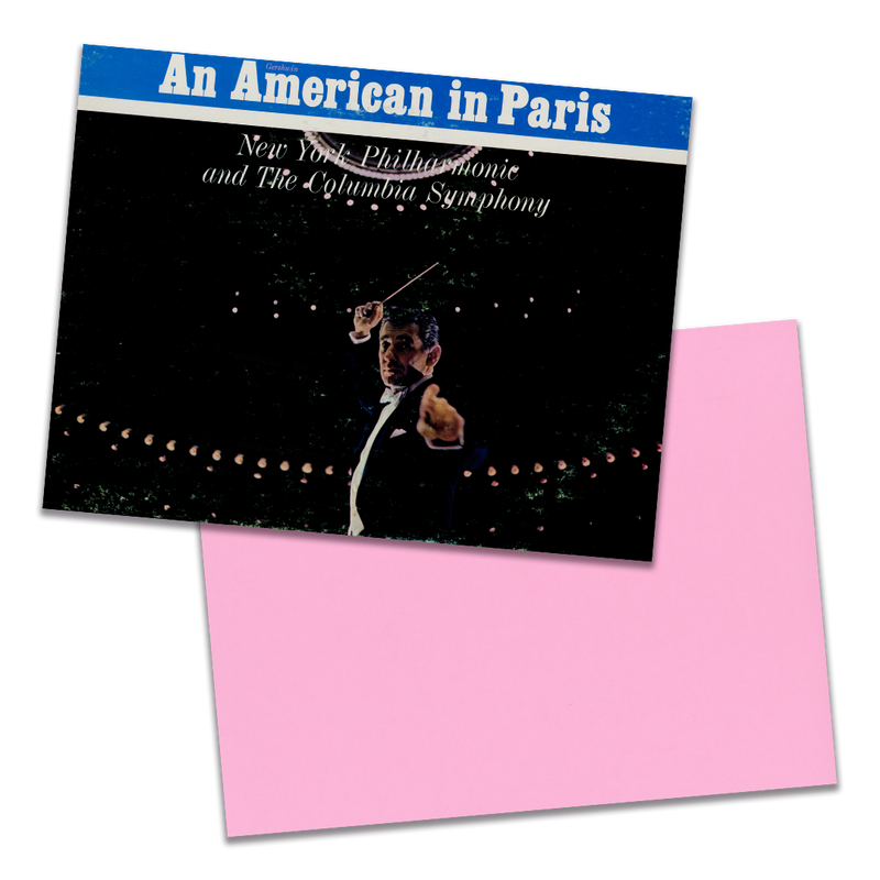 Photo of a 11” x 8.5” notebook cover made from an upcycled Gershwin, Leonard Bernstein “Rhapsody In Blue / An American In Paris” album sleeve and the back cover with pink cardstock on a transparent background.