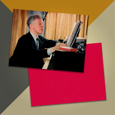 Photo of a 11” x 8.5” notebook cover made from an upcycled Beethoven, Rubinstein, Symphony Of The Air, Krips “Concerto No. 5 (Emperor)” album sleeve and the back cover with red cardstock on an orange, cream and grey background.