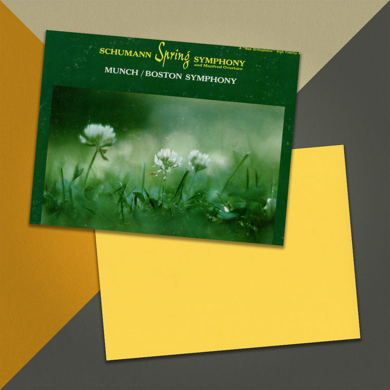 Photo of a 11” x 8.5” notebook cover made from an upcycled Schumann : Munch / Boston Symphony “Spring Symphony And Manfred Overture” album sleeve and the back cover with yellow cardstock on an orange, cream and grey background.