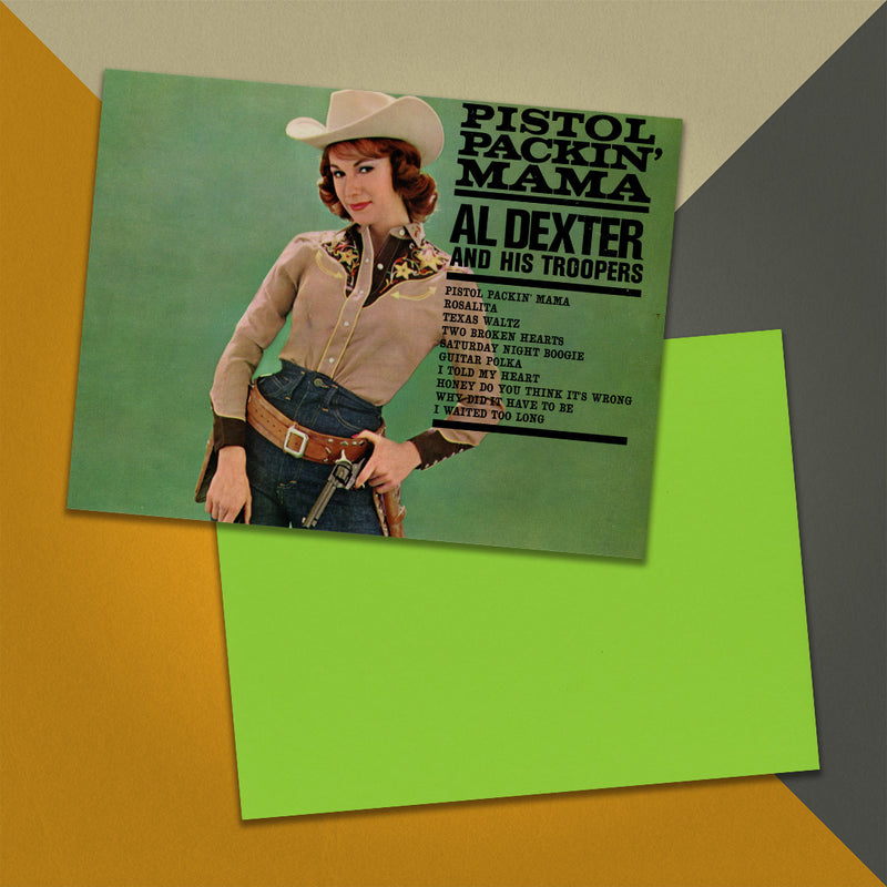 Photo of a 11” x 8.5” notebook cover made from an upcycled Al Dexter And His Troopers “Pistol Packin’ Mama” album sleeve and the back cover with lime green cardstock on an orange, cream and grey background.