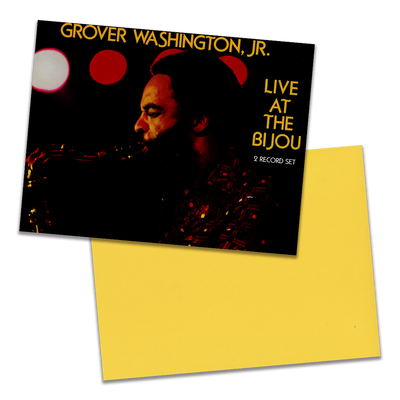 Photo of a 11” x 8.5” notebook cover made from an upcycled Grover Washington, Jr “Live At The Bijou” album sleeve and the back cover with yellow cardstock on a transparent background.