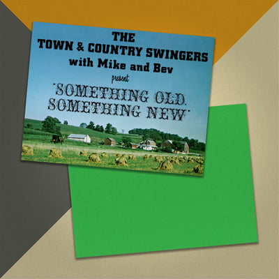 Photo of a 11” x 8.5” notebook cover made from an upcycled The Town & Country Swingers with Mike and Bev “Something Old, Something New” album sleeve and the back cover with green cardstock on an orange, cream and grey background.