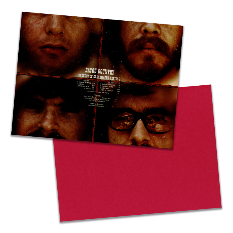 Photo of a 11” x 8.5” notebook cover made from an upcycled Creedence Clearwater Revival “Bayou Country” album sleeve and the back cover with red cardstock on a transparent background.