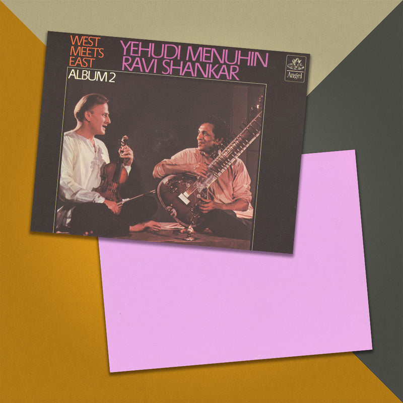 Photo of a 11” x 8.5” notebook cover made from an upcycled Yehudi Menuhin & Ravi Shankar "West Meets East - Album 2" album sleeve and the back cover with purple cardstock on an orange, cream and grey background.