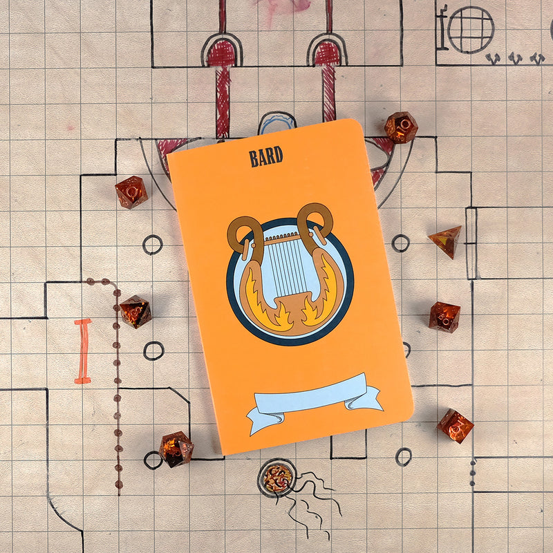 The front cover of a large bard notebook with a bright orange cover and an illustration of a lyre. The notebook sits on a grid map surrounded by dice.