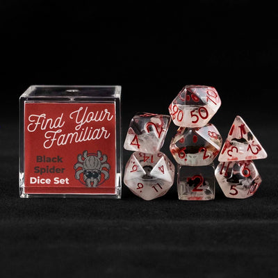 A set of clear and cloudy polyhedral dice with black spider inclusions sitting to the right of a small acrylic box with the words "Find Your Familiar" and "Black Spider Dice Set" on a black background.