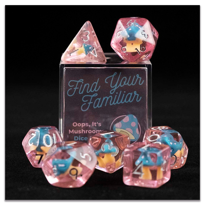 A set of pink polyhedral dice with blue and pink cap mushroom inclusions sitting on top and around a small acrylic box with the words "Find Your Familiar" and "Oops, It's Mushrooms Dice Set" on a transparent background.