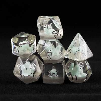 A set of clear polyhedral dice with blue triceratops inclusions on a black background.