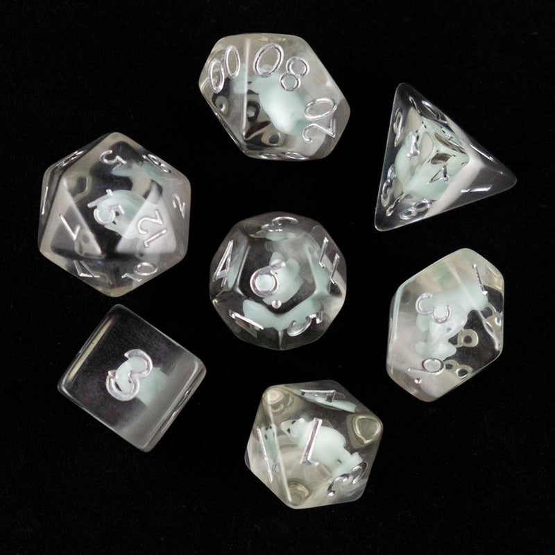 A set of clear polyhedral dice with blue triceratops inclusions from above on a black background.