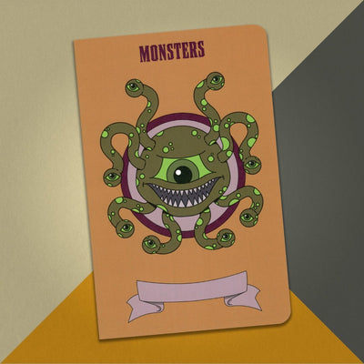 A large rusty orange monsters notebook with an illustration of a green Beholder on an orange, cream and grey background.