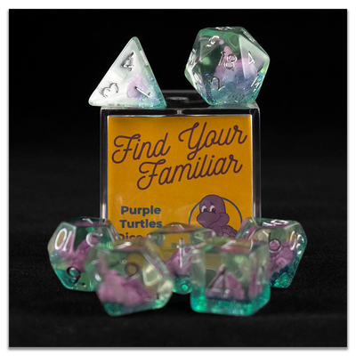 A set of clear green polyhedral dice with purple turtle inclusions sitting on top and around a small acrylic box with the words "Find Your Familiar" and "Purple Turtles Dice Set" on a transparent background.