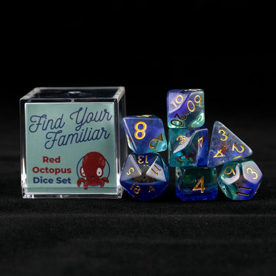 A set of clear green and blue polyhedral dice with red octopus inclusions sitting to the right of a small acrylic box with the words "Find Your Familiar" and "Red Octopus Dice Set" on a black background.