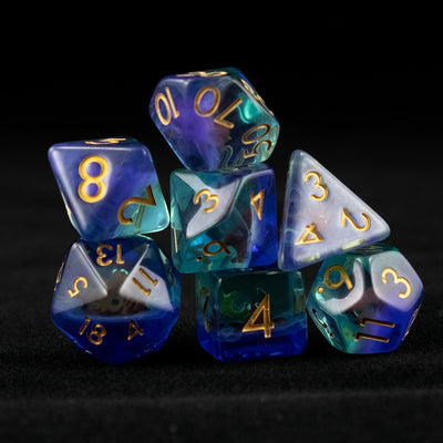 A set of clear green and blue polyhedral dice with red octopus inclusions on a black background.