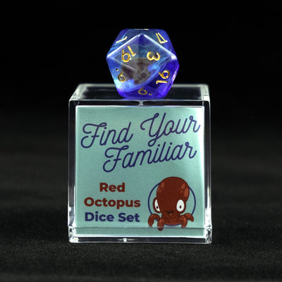 A 20 sided clear green and blue die with red octopus inclusions sitting on top of a small acrylic box with the words "Find Your Familiar" and "Red Octopus Dice Set" on a black background.