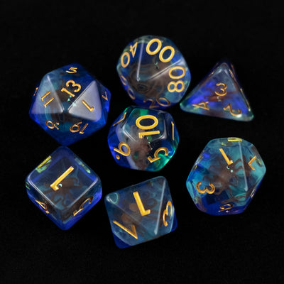 A set of clear green and blue polyhedral dice with red octopus inclusions from above on a black background.