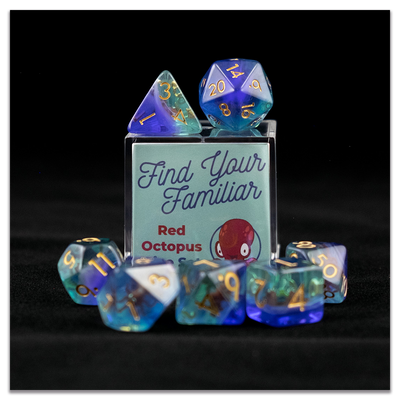 A set of clear green and blue polyhedral dice with red octopus inclusions sitting on top and around a small acrylic box with the words "Find Your Familiar" and "Red Octopus Dice Set" on a transparent background.