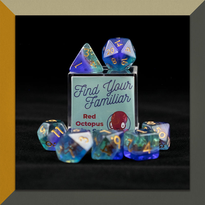 A set of clear green and blue polyhedral dice with red octopus inclusions sitting on top and around a small acrylic box with the words "Find Your Familiar" and "Red Octopus Dice Set" on an orange, cream and grey background.