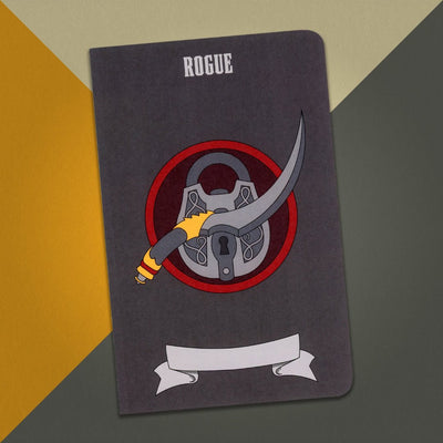 A large rogue notebook with a dark gray cover and an illustration of a dagger and lock on an orange, cream and grey background.