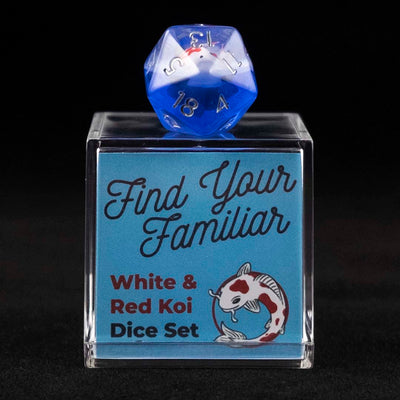 A 20 sided clear and blue die with red and white koi inclusions sitting on top of a small acrylic box with the words "Find Your Familiar" and "Red & White Koi Dice Set" on a black background.